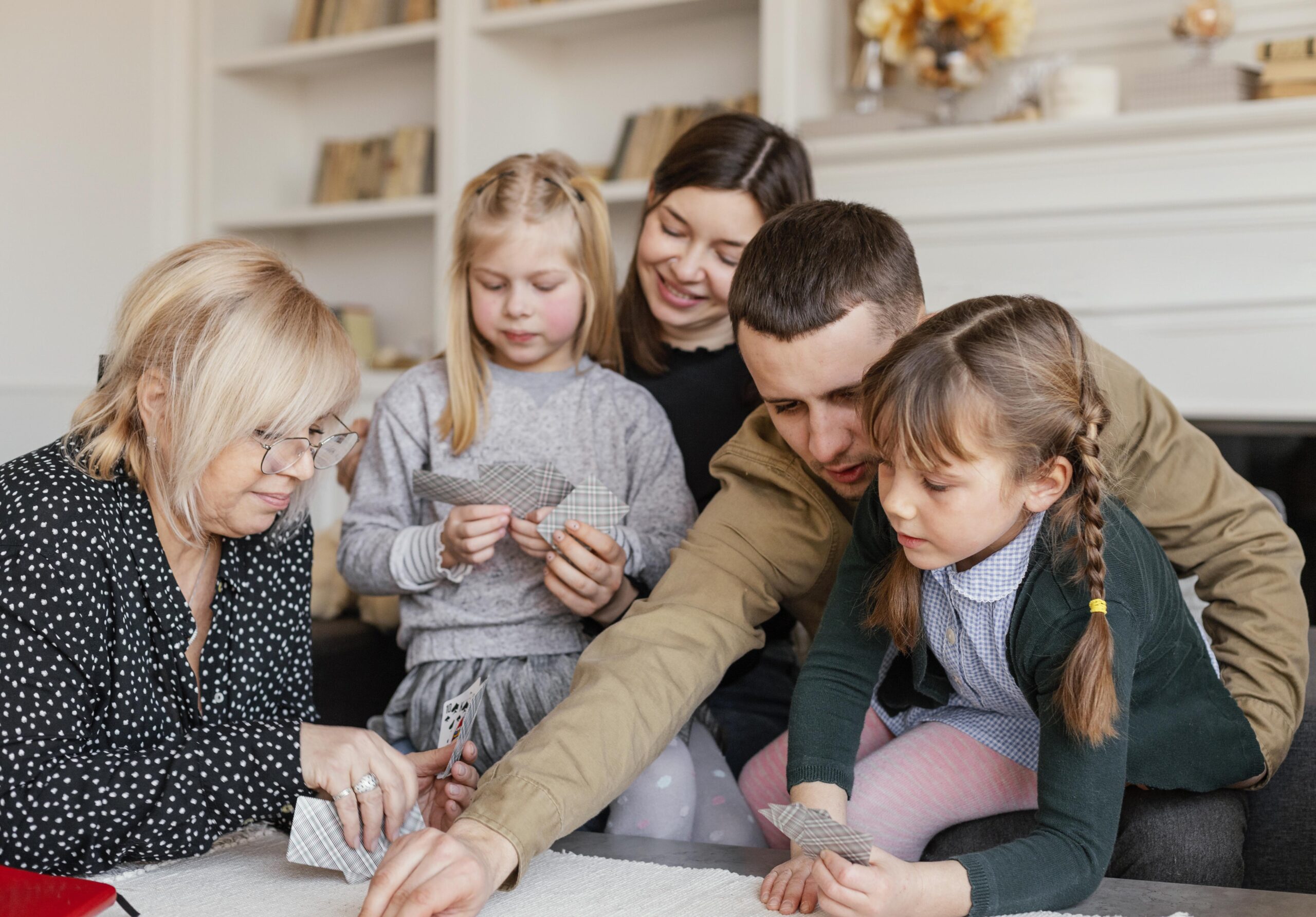 medium shot family playing cards